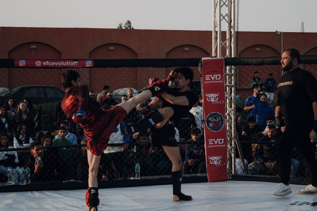 A couple of men standing on top of a wrestling ring